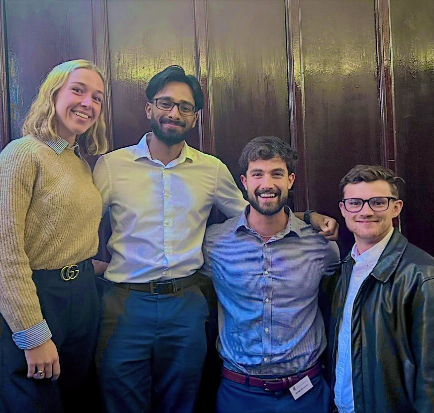 Four poster competition participants posing together